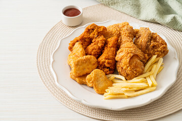 fried chicken with french fries and nuggets on plate