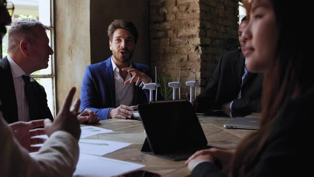 Multiethnic business people working on sustainable renewable energy project inside office - Green alternative electricity concept