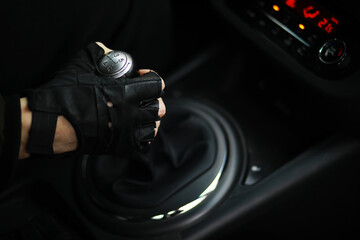 Hand on the car gear knob. The driver switches the speed in the car. Hand on gear lever.