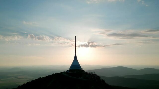 Silhouette of Jested Tower, Hotel, Restaurand and TV Tower in Liberec Czech Republic with sun setting in background