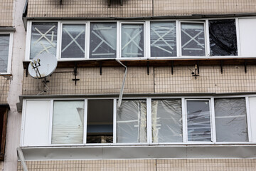 KYIV, UKRAINE - APR 21, 2022: The facade of an apartment building on Koshytsia str. was destroyed...