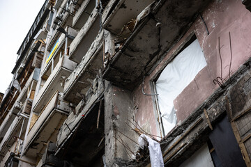 KYIV, UKRAINE - APR 21, 2022: The facade of an apartment building on Koshytsia str. was destroyed...
