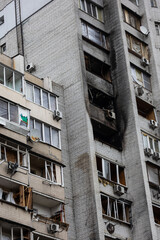 Fototapeta premium KYIV, UKRAINE - APR 21, 2022: The facade of an apartment building on Koshytsia str. was destroyed by the Kalibr cruise missile on the second day of the full-scale Russian invasion of Ukraine.