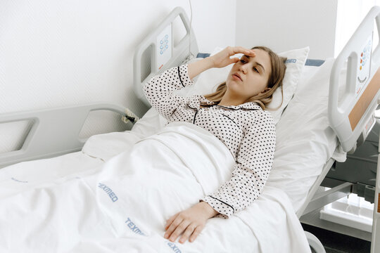 a woman hospitalized, Young woman lying in a hospital bed, medicine and healthcare concept