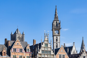 Fototapeta na wymiar Ancient gable houses and clock tower along the Korenlei in Ghent port city in northwest Belgium during a sunny day
