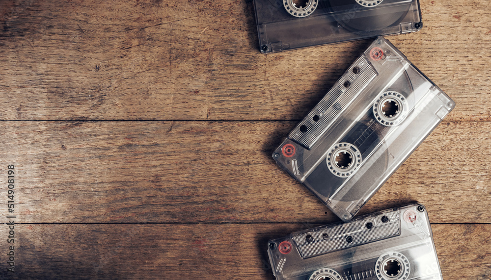 Poster beautiful audio cassette tape on a brown old wooden table. minimalism retro style concept. 80s. back