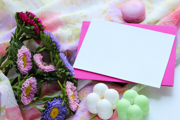 greeting card postcard. a bouquet of multi-colored asters, handmade soy candles and a white blank for text