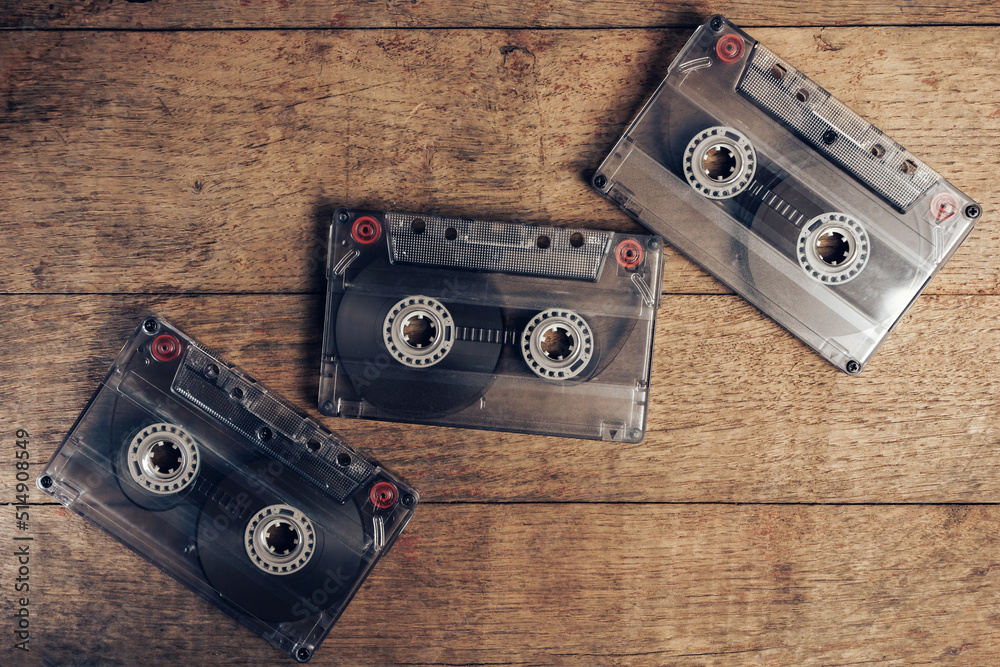 Poster beautiful audio cassette tape on a brown old wooden table. minimalism retro style concept. 80s. back