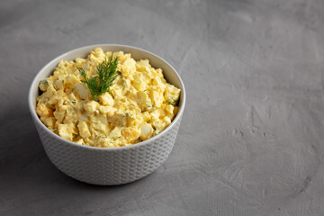 Homemade Egg Salad with Dill in a Bowl, side view. Copy space.