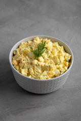 Homemade Egg Salad with Dill in a Bowl, side view.
