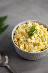 Homemade Egg Salad with Dill in a Bowl, side view.
