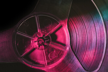 Close up old vintage Reel tape recorder in color light. Background pattern texture for design.