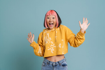 Asian girl with pink hair and piercing expressing surprise at camera