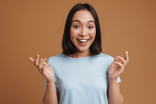 Young Asian Woman Expressing Surprise At Camera