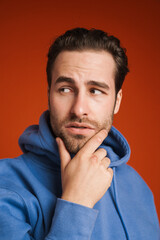 Fototapeta premium Young white man wearing hoodie posing and looking aside