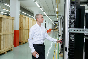 Businessman opening door of data server in industry