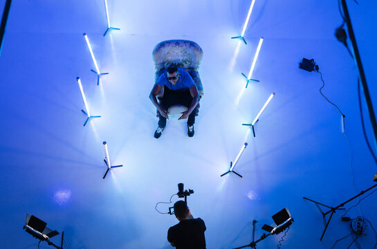 Cameraman filming rapper in studio set