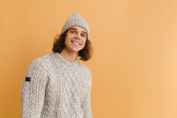 Young handsome man with long hair in winter hat