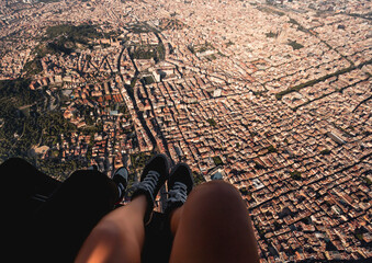 Spain, Catalonia, Barcelona, Personal perspective of young woman riding helicopter over densely populated residential district