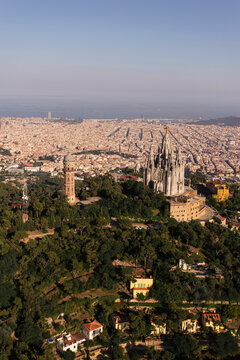 Spain, Catalonia, Barcelona, Helicopter view of Tibidabo hill with Temple Expiatori del Sagrat Cor church and Torre de las Aguas de Dos Rios water tower