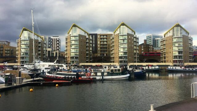 Docklands light rail train passes across Limehouse Basin near Isle of Dogs in East London
