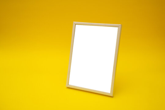 White photo frame on yellow background