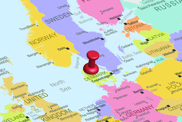 Naklejka premium Denmark with red fastener pushpin on europe map, close up Denmark, travel idea, colorful map with location icon, vacation concept