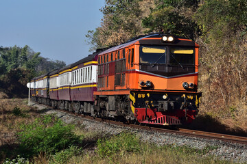 Fototapeta premium Thai passenger train by diesel locomotive on the railway.