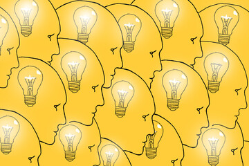 Profiles of human heads with light bulbs inside. The concept of collective thinking, creativity and teamwork.