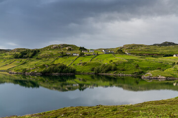 view of Loch Inchard and the hamlet of Achriesgill in the Scottish Highlands in warm evening light © makasana photo