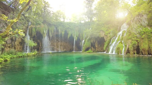 sunshine on underwater trees of the Galovacki Buk waterfall of Plitvice National Park in Croatia. Milino Jezero lake and forest in Lika region. UNESCO World Heritage of Croatia named Plitvicka Jezera