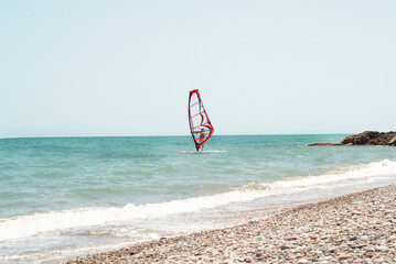 man on surfboard with sail sea.a man on a surfboard with a sail sea, water sports in the mediterranean sea