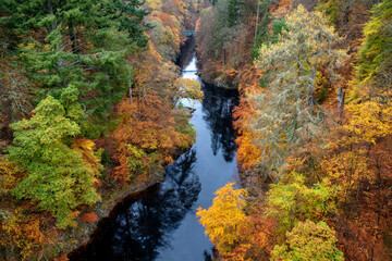 Autumn colours at the wooded river gorge where one of the goriest battles in Jacobite history took place near Pictlochry Scotland