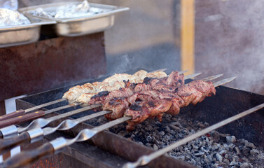 Ready-made food on fire, barbecue - meat skewers and burgers