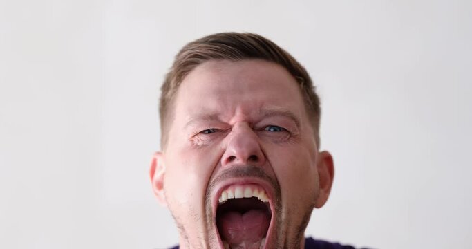 Irritated emotional man screaming with furious look