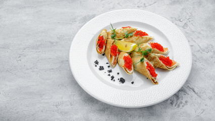 Pancakes with salmon, cream cheese and Tobiko caviar. on a white background