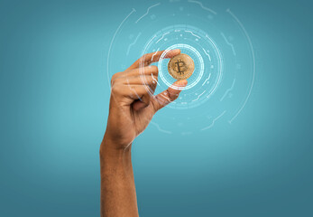 cryptocurrency, finance and business concept - close up of female hand holding golden bitcoin over...