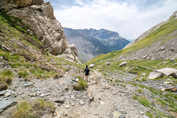 Female hiker descending from Lake "Ibon de Bernatuara " in the Ordesa and Monte Perdido National park.