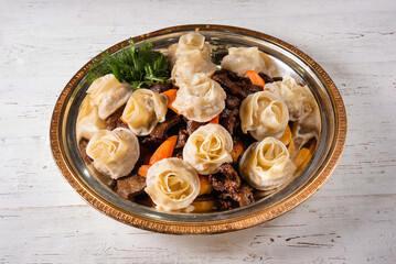 lyagan with manta rays, meat and vegetables. on a white wooden background