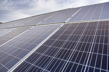 economical newly installed shiny solar panels that sparkle under the sky and the sun's rays.