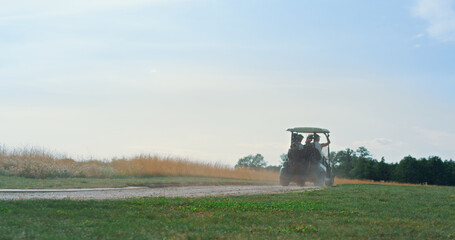 Golf cart driving fairway outside. Golfing players exploring course on sunny day