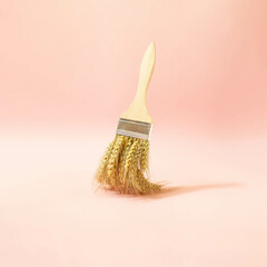 Creative composition with paint brush handle and ripe ear of wheat against pastel pink background. Good harvest minimal concept.