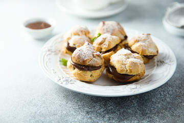 Homemade profiteroles with chocolate paste