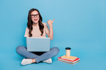 Photo of lady university student sit use netbook point empty space school ads discount isolated...