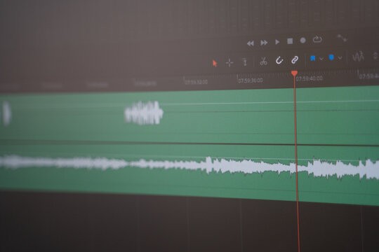 Editing and working with sound in a special program. Monitor screen with audio track