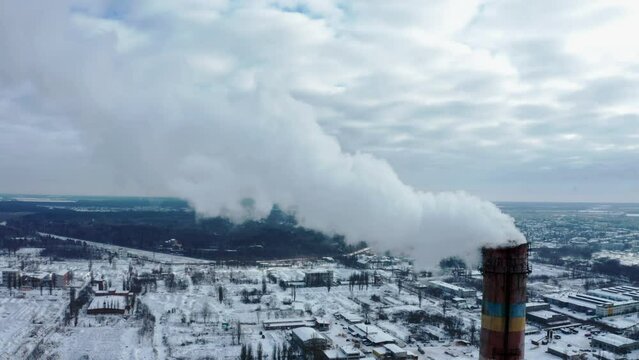 Air environment pollution concept. Smoke or hot steam from tube chimney of power chemical petrochemical oil and gas refinery plant complex. Industrial winter landscape. TPP. TPS.