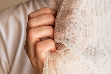 woman gripping fabric tulle in her hands
