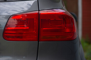 Close-up photo of the right rear light of a sports car on the street