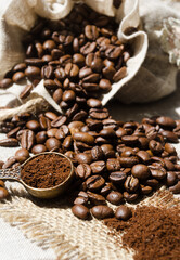 Coffee beans and ground close-up on burlap.