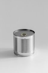 food storage and eating concept - close up of tin can with preserve on table